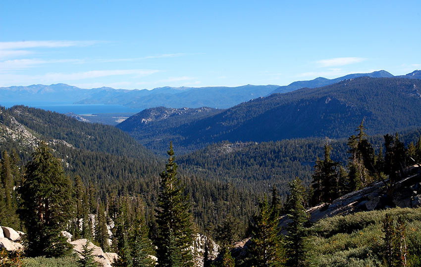 Looking across the forest and mountains to see Lake Tahoe