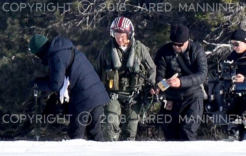 Tom Cruise being attended to by a member of the Top Gun: Maverick production team