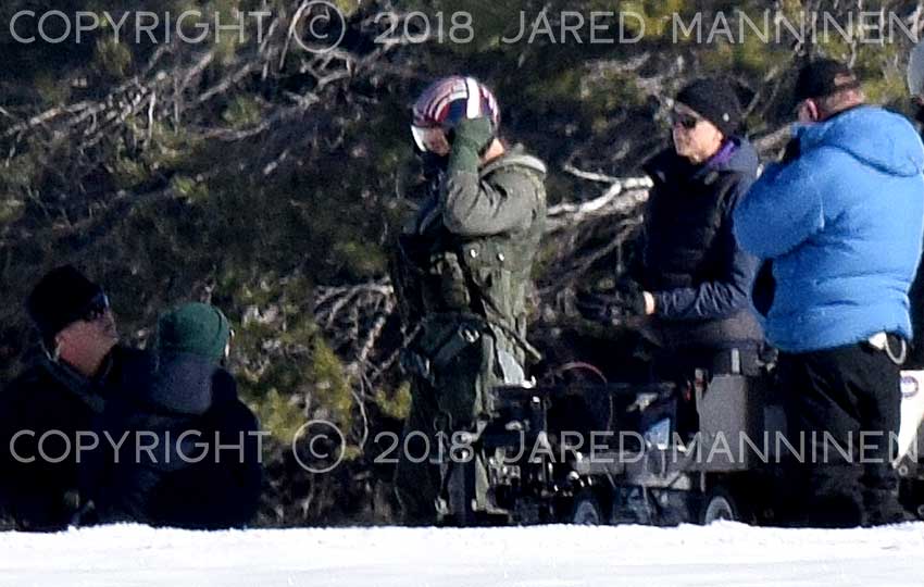 Tom Cruise putting on his flight helmet