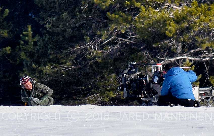 Tom Cruise takes a knee to release himself from his parachute harness while filming Top Gun: Maverick