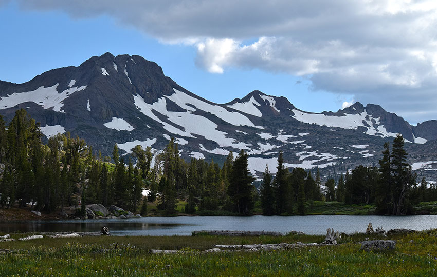 Mountains with patches of snow and a small lake