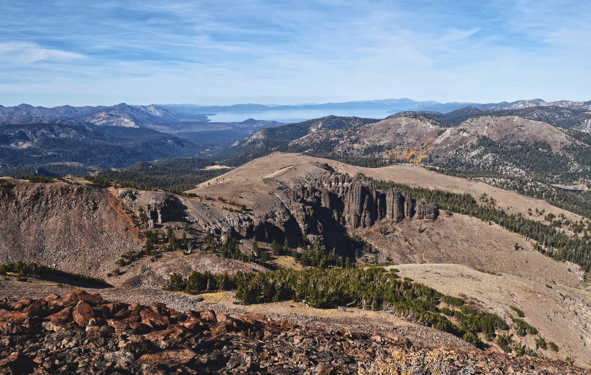 Autumn mountains with blue skies and clouds and lake