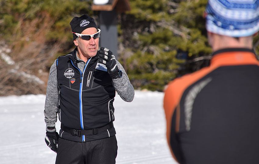 Cross-country ski instructor demonstrating technique to a student