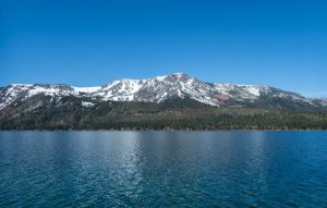 Snow covered mountains behind an alpine lake