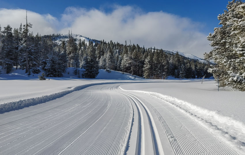 Groomed cross-country ski trail with blue skies