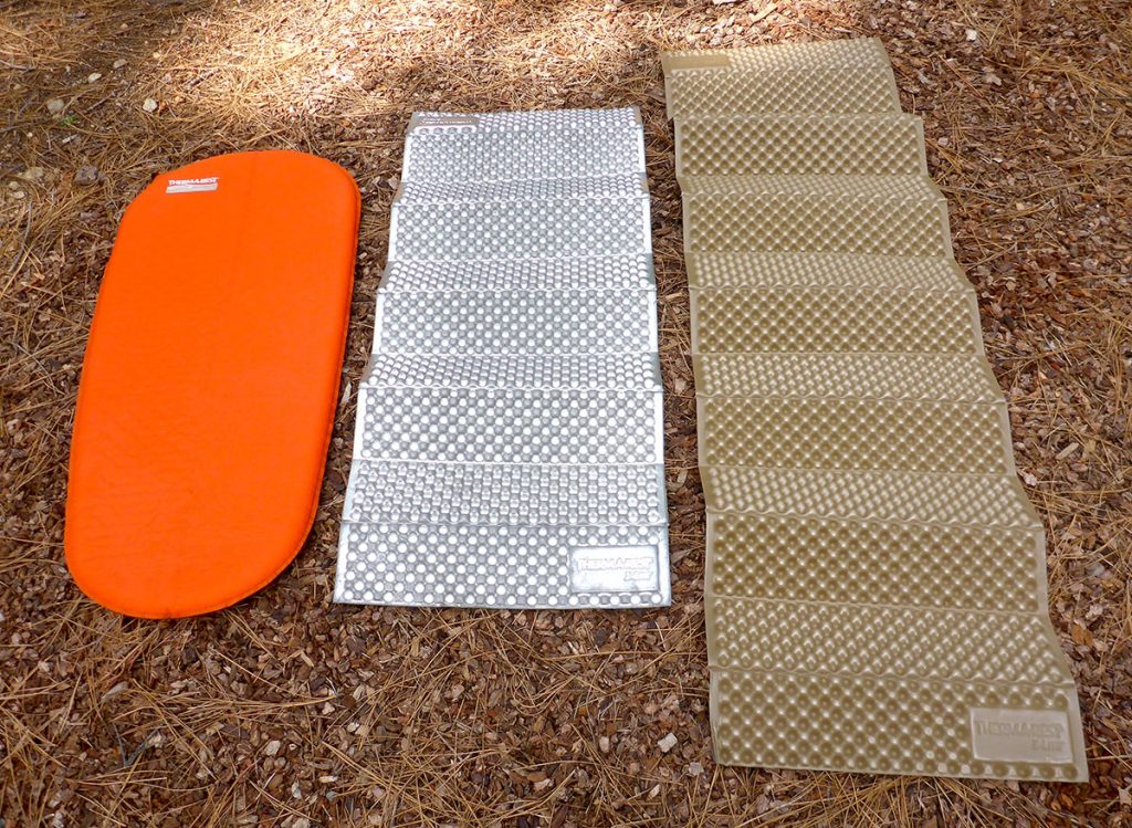 Three different sizes and styles of backpacking sleeping pads