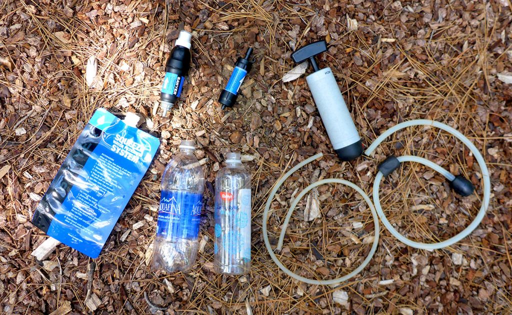 Assortment of backpacking water filtration systems