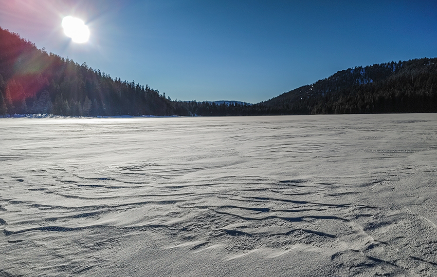 Wind-scoured snow and mountains